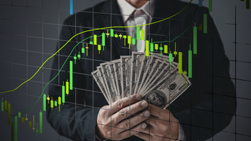 man holding money representing profits with a stock graphic in front