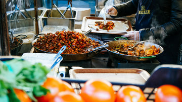 plate of really hot good delicious food. Restaurant owner cooking with tomatoes in the foreground