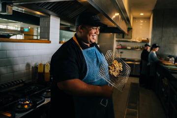chef smiling in the kitchen after frying