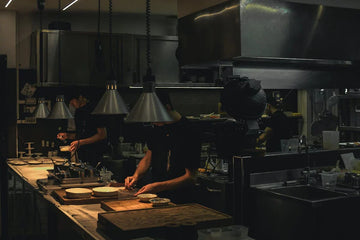  Multiple chefs working together in a busy commercial restaurant kitchen