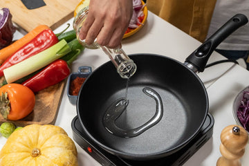 Pouring cooking oil into frying pan in commercial kitchen