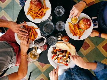 family eating a lot of good burgers and fries