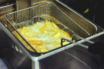 Frying french fries in oil deep fryer vat