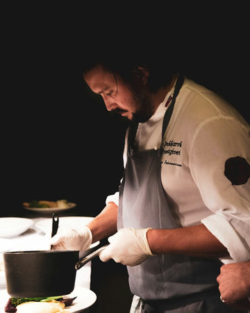 Night time dining chef making gourmet meal in dark room