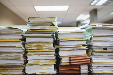 documents piled up and fryer logs in a work place environment operating a restaurant