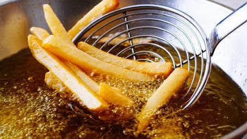french fries being fried in deep fryer with clean frying oil