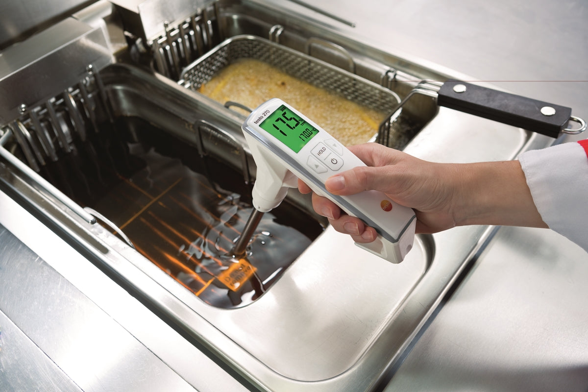 Commercial frying oil being tested with an oil quality meter